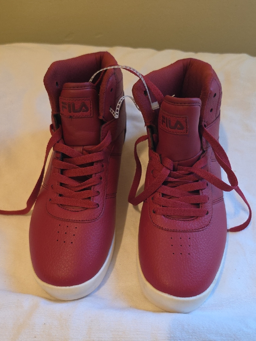 Red Fila Impress LL mid-top sneakers with white soles.